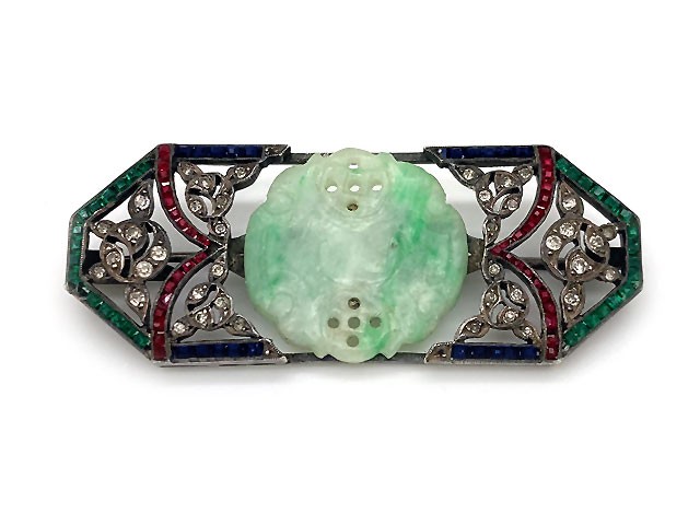 A rainbow of colors are abound in this lovely antique Art Deco jade brooch.  Made in sterling silver with blue, green,red and white paste stones.