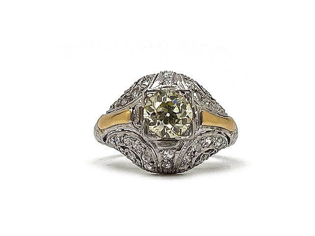 A beautiful Art Deco diamond ring with a center diamond weighing approximatly 0.74cts mounted in a dome setting with high polish rose gold on either side.